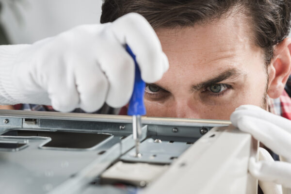close-up-male-technician-repairing-cpu-with-screwdriver